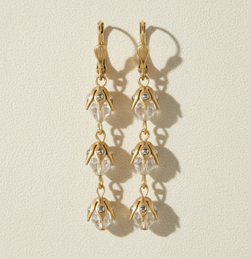 Gold-tone floral drop earrings with crystal teardrop charms and hook closures