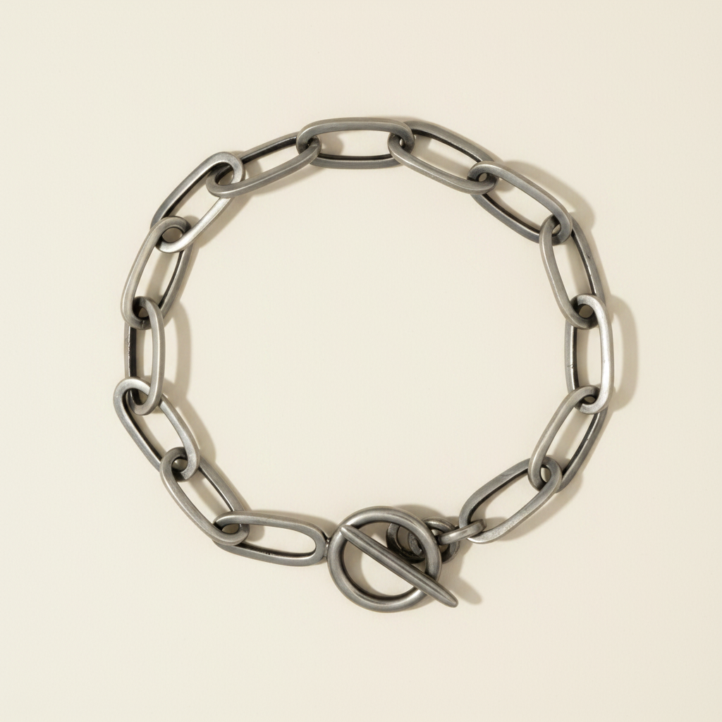 Silver-toned rectangle link bracelet with integrated clasp, flat view