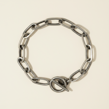 Silver-toned rectangle link bracelet with integrated clasp, flat view