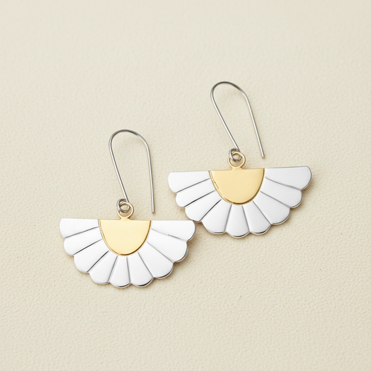 Gold and white fan-shaped drop earrings with scalloped petals, on curved hooks.
