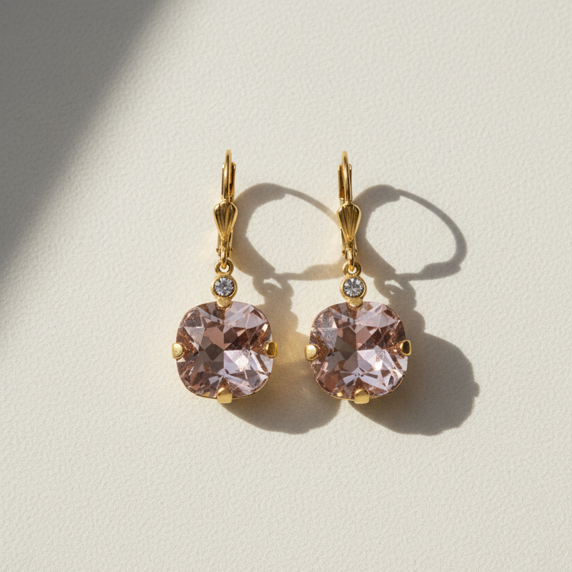 Gold-tone drop earrings with round faceted blush stones and small clear accents