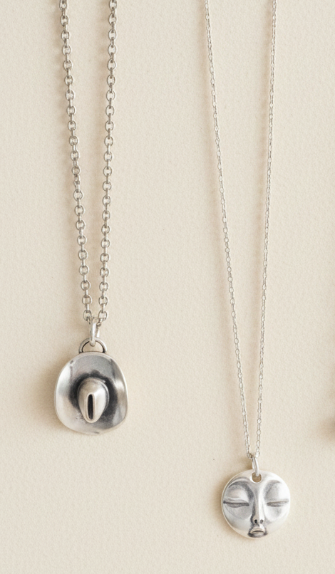 Silver-tone cowboy hat charm necklace with circular pendant and link chain