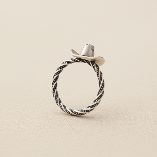Silver cowboy hat ring with braided rope band and dark swirl detailing