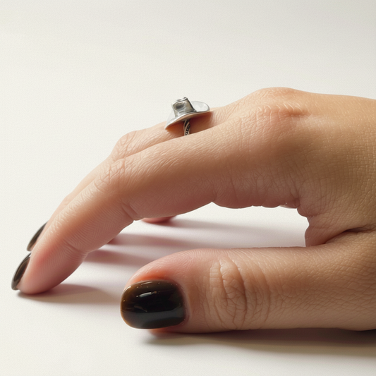 Cowboy hat ring on hand, silver band with dark patterned rope inlay