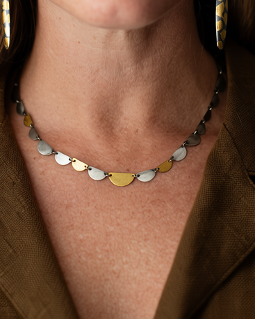 Hemi disc necklace with alternating silver, gold, and light green half-moon charms