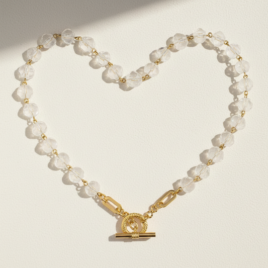 Clear crystal beaded necklace with gold-tone round pendant