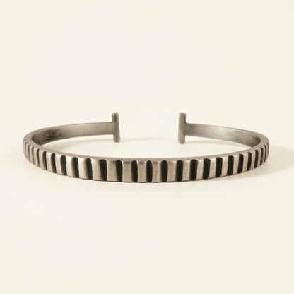 Silver striped cuff bracelet with vertical carved ridges and two raised end bars