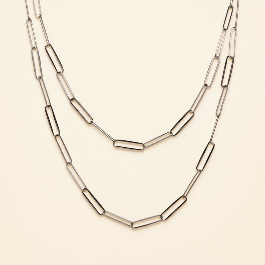 Layered paperclip-link chain necklace with curved bar links, silver-tone.