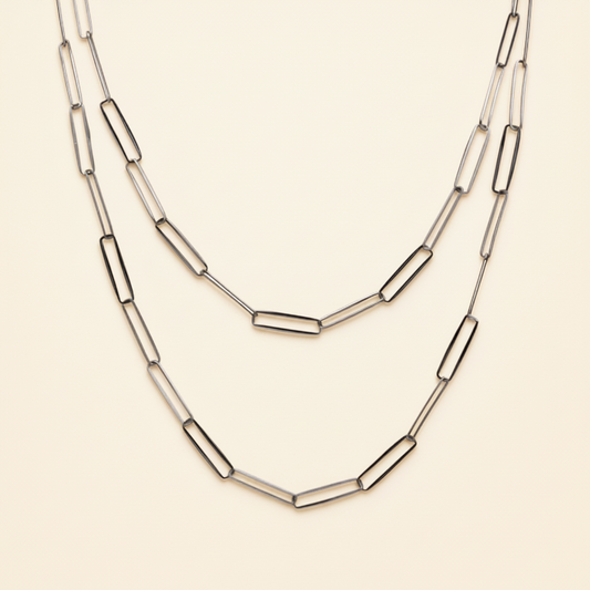Layered paperclip-link chain necklace with curved bar links, silver-tone.