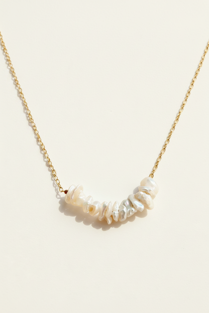 Keishi pearl row necklace, gold chain with white irregular pearls along curve