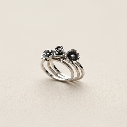 Silver ring with floral designs on a white background