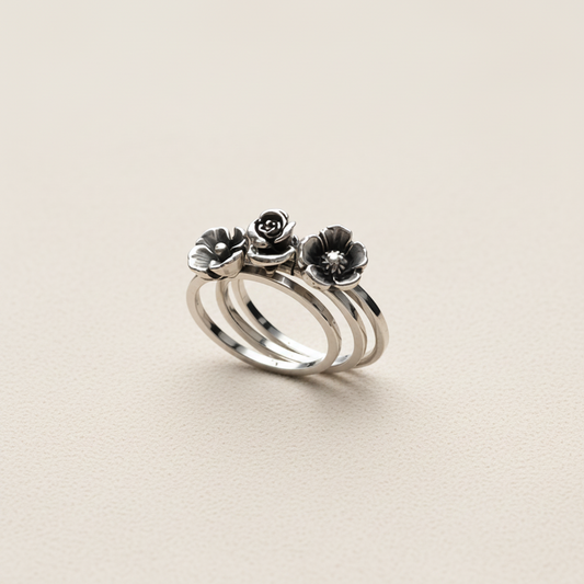 Silver ring with floral designs on a white background