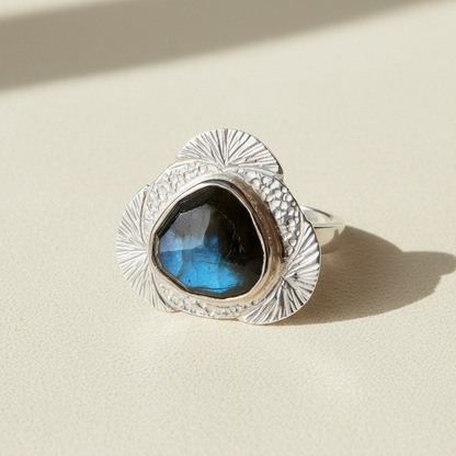 Teardrop labradorite ring with hammered silver bezel and sunburst edge detail