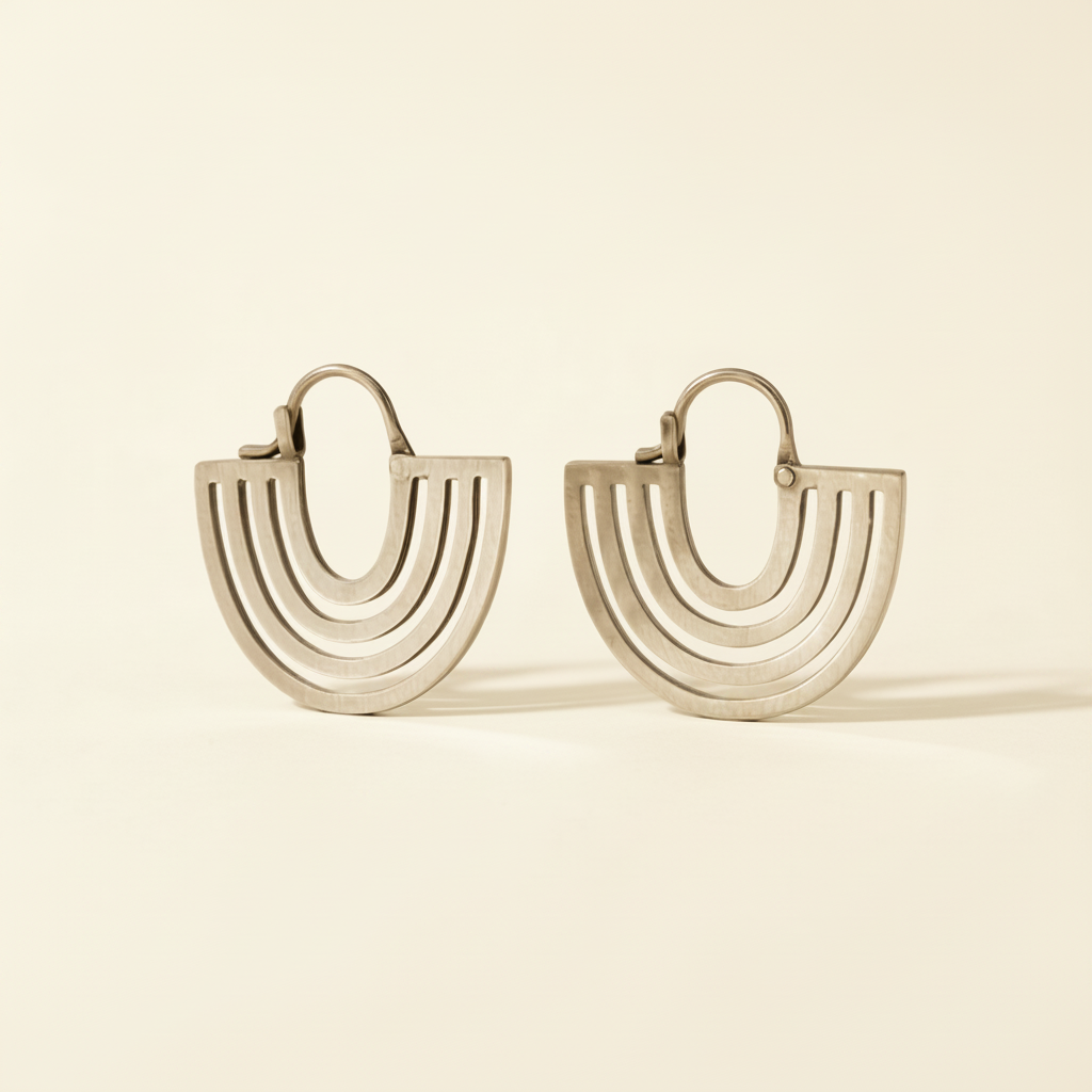 Hand cut hoop earrings with stacked curved lines and hinged backs, silver-tone finish