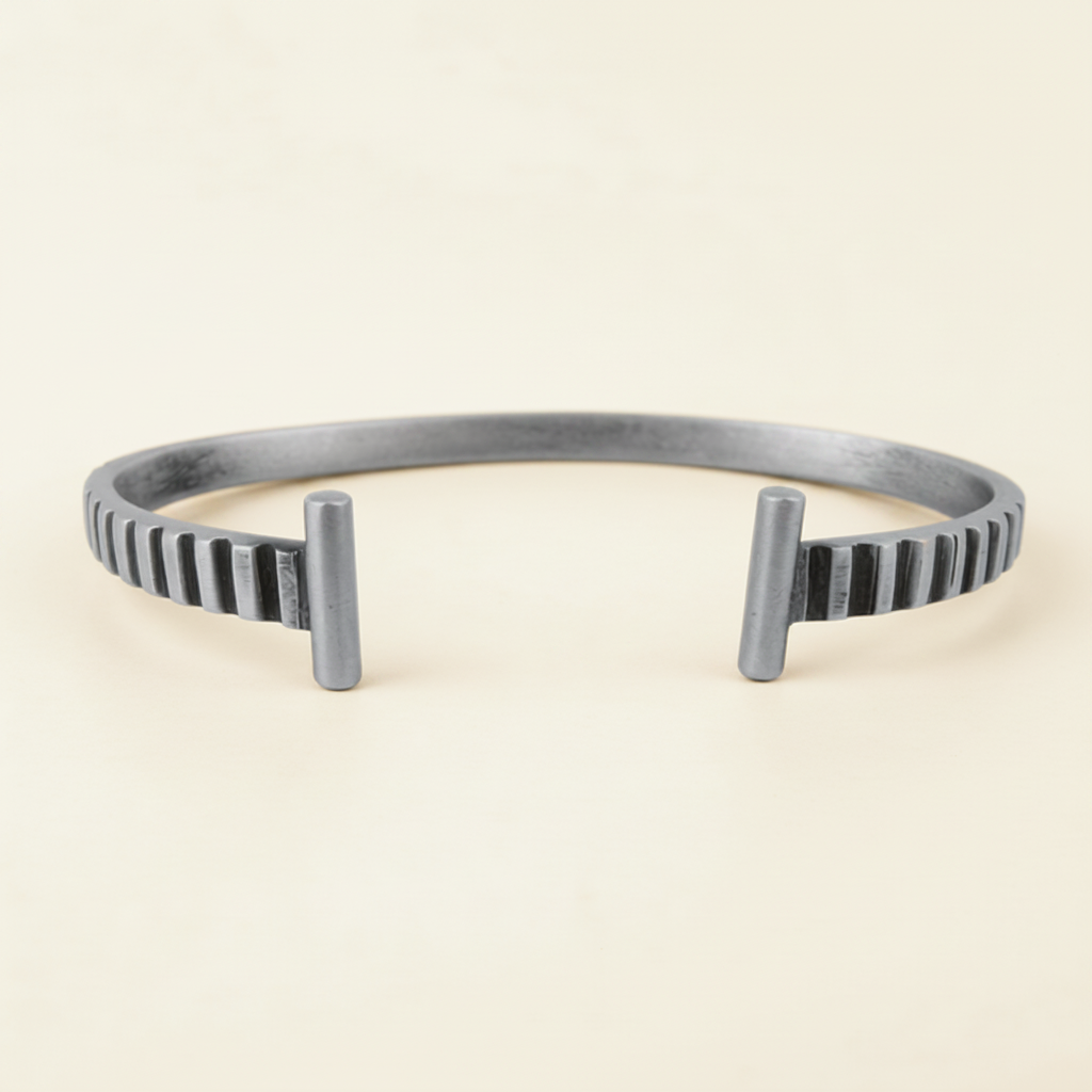 Silver striped cuff bracelet side view, vertical ridges and raised posts at ends