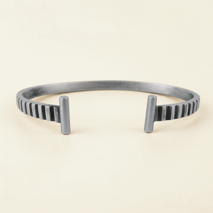 Silver striped cuff bracelet side view, vertical ridges and raised posts at ends