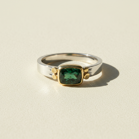 Tourmaline aura ring with faceted dark-green square stone on silver band with gold details