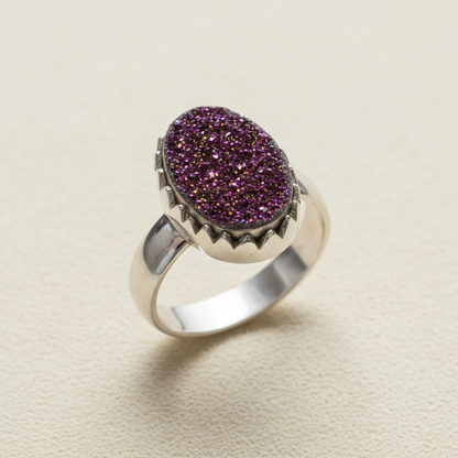 Oval druzy ring with purple sparkling center and silver-tone band