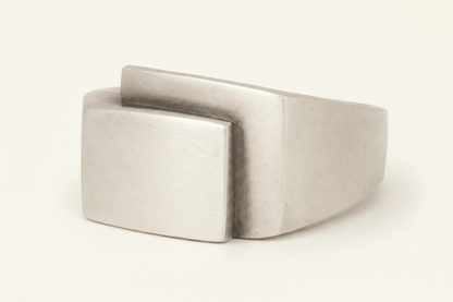 Silver-gray fold-over deco ring with square top and stepped folded band
