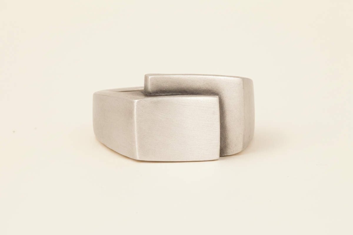 Silver-gray fold-over deco ring with square center face and wide band