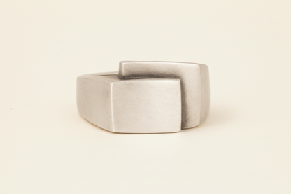 Silver-gray fold-over deco ring with square center face and wide band