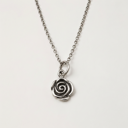 Silver-tone rose swirl pendant on short chain with round clasp