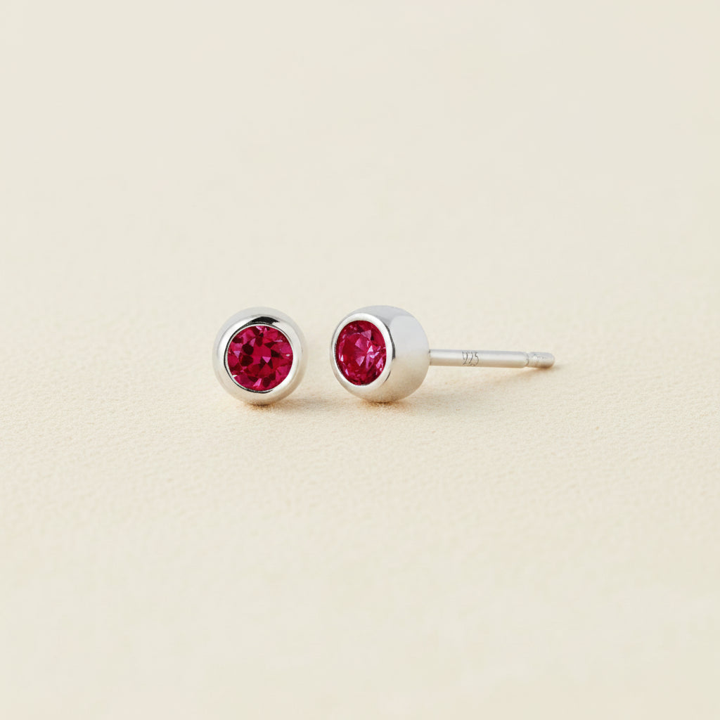 Tiny birthstone stud earrings with round red ruby CZ in silver-tone settings