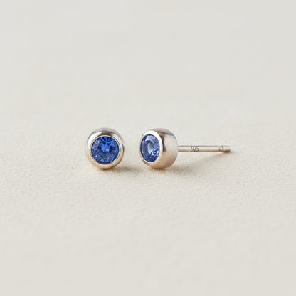 Tiny birthstone stud earrings with round blue sapphire CZ in silver-tone settings