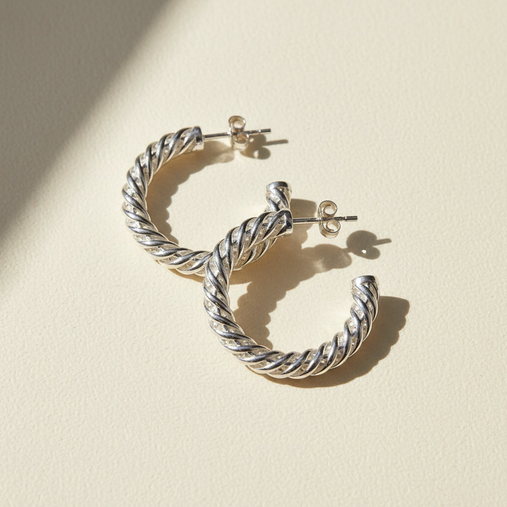 Silver spiral hoop earrings with twisted rope design and latch-back closures