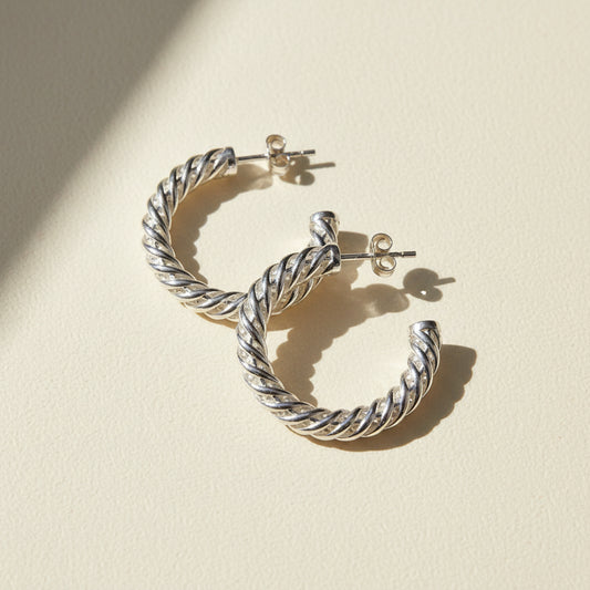 Silver spiral hoop earrings with twisted rope design and latch-back closures