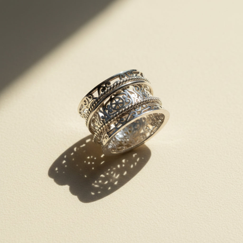 Silver-tone wide band filigree spinner ring with stacked engraved bands