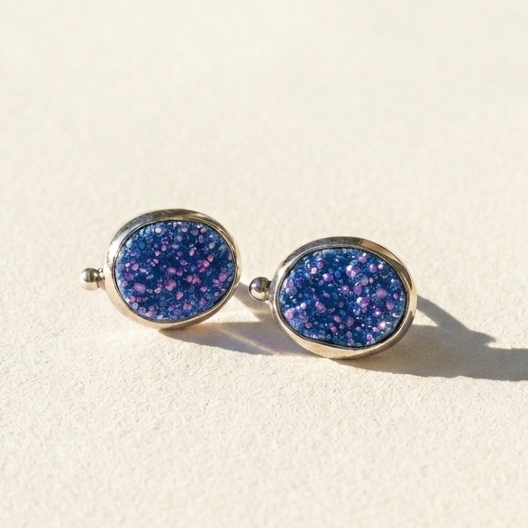 Oval blue-purple stud earrings with sparkling speckled gemstone-style face