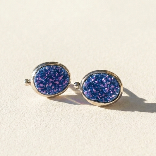 Oval blue-purple stud earrings with sparkling speckled gemstone-style face