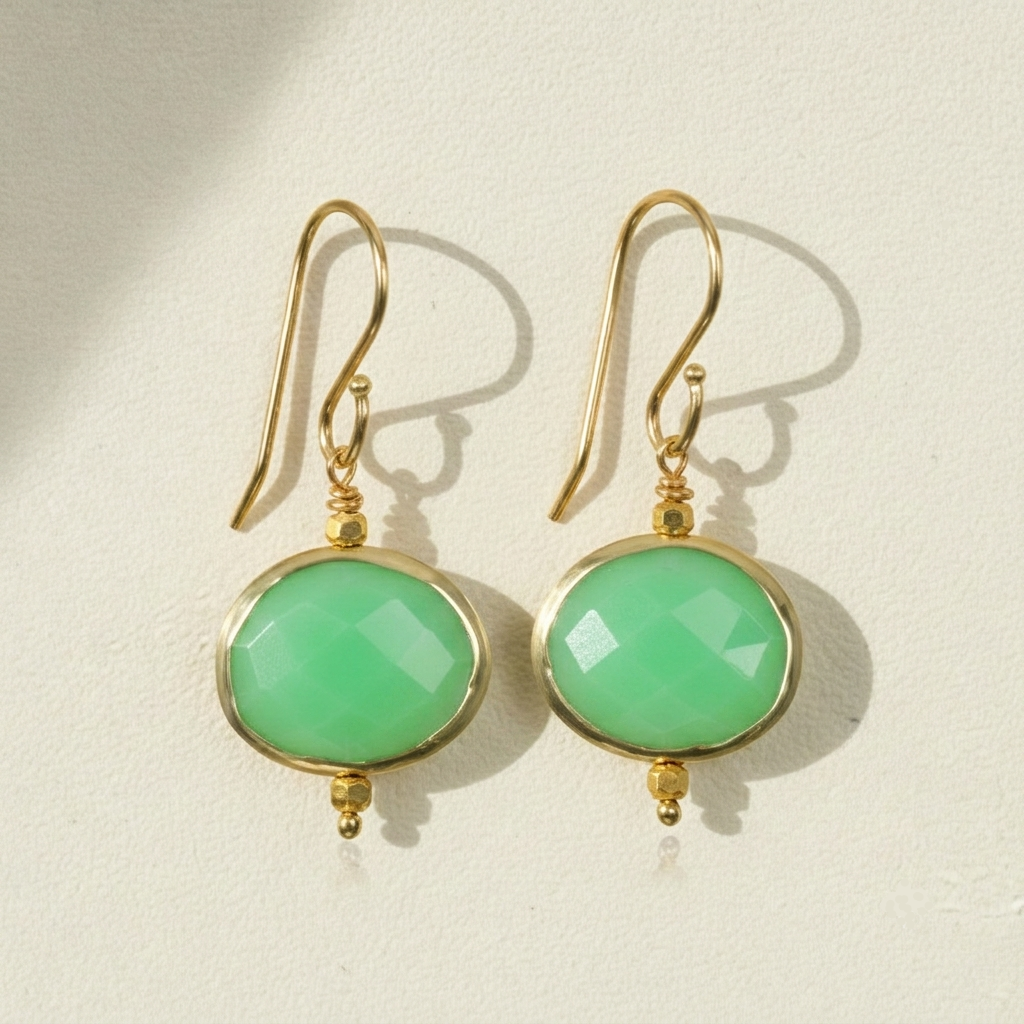 Gold-tone drop earrings with round green faceted bezel stones and fishhook backs